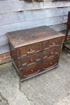 An 18th century oak chest of three drawers with fielded panel fronts and knob handles, 32" wide x