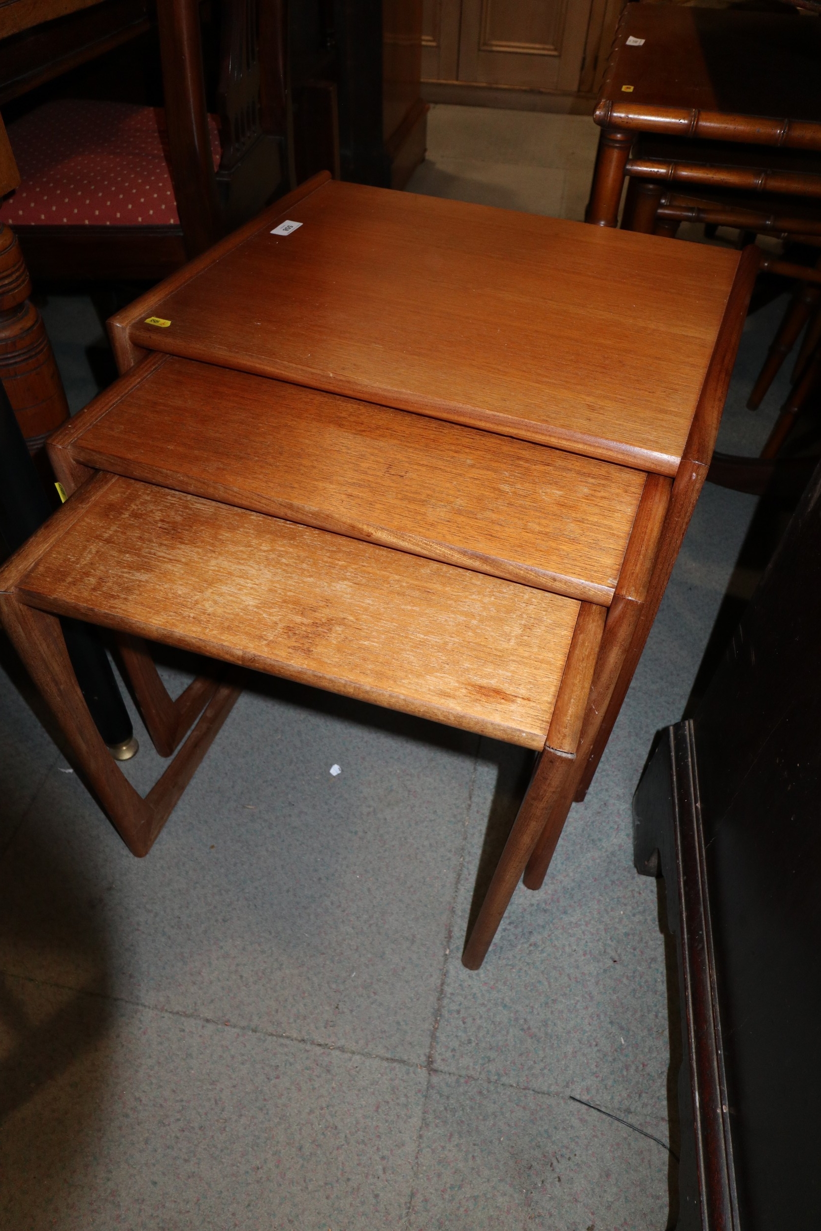 A nest of three G Plan teak occasional tables, largest 21" wide x 17" deep x 19" high, and a similar