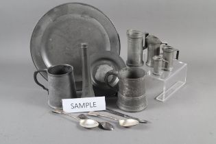 A pewter charger, a set of Continental pewter measures and other pewter