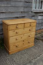 A waxed pine chest of two short and three long drawers with knob handles, on block base, 41" wide