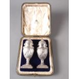 A pair of Adam style silver pedestal pepper shakers, in fitted case, 4.6oz troy approx