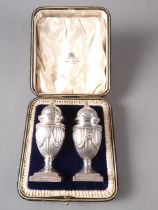 A pair of Adam style silver pedestal pepper shakers, in fitted case, 4.6oz troy approx