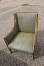 An Edwardian walnut line inlaid armchair, upholstered in a clouded green, on square taper supports