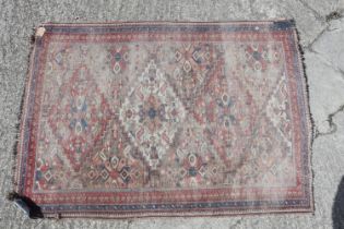 A Kazak style rug with three medallions, 72" x 50" approx (very worn), a Caucasian rug with blue