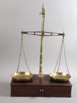 A 19th century W & T Avery brass balance, on mahogany stand, fitted drawer, 15" wide, an early