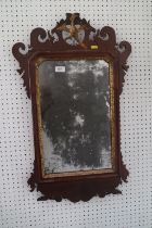 An 18th century walnut framed wall mirror with Hoho bird crest, shaped plate 18" x 11", 30" high
