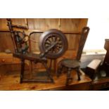 An oak and ash upright spinning wheel, 33" high, and a chip carved oak spinning stool with octagonal