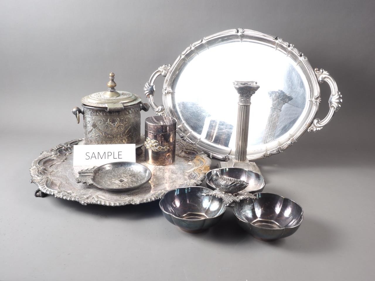 A silver plated engraved biscuit box, a plated and engraved salver, two plated trays and other items