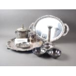 A silver plated engraved biscuit box, a plated and engraved salver, two plated trays and other items