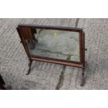 A 19th century mahogany swing frame toilet mirror, on skeleton stand, 23" wide x 19" high