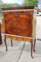An early 18th century figured walnut and feather banded secretaire abbatant, the upper section