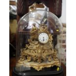 A 19th century French gilt metal mantel clock with white enamelled dial and attendant figure,