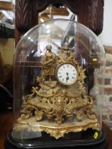 A 19th century French gilt metal mantel clock with white enamelled dial and attendant figure,