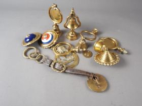 Five early 20th century brass single top swingers and other brass harness fittings