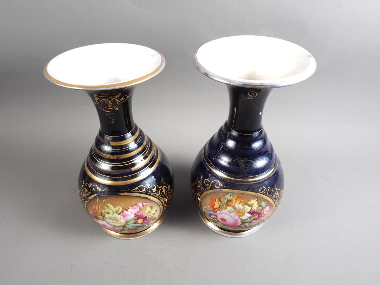 A pair of early 19th century bone china vases with flared rims and floral reserve panels on a blue - Image 2 of 16