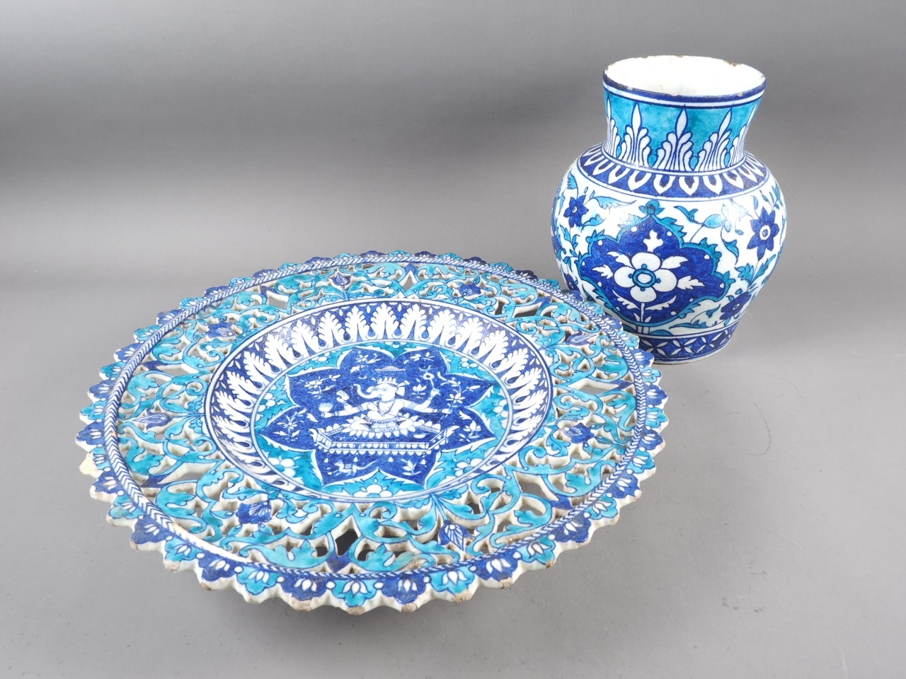 A Persian frit ware vase with all-over floral design in blue and turquoise, 9 1/4" high, and a