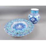 A Persian frit ware vase with all-over floral design in blue and turquoise, 9 1/4" high, and a