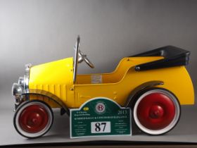 A Great Gizmos painted metal pedal car, in the vintage style, and a Bentley Drivers Club Rally sign