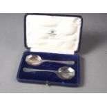 A pair of silver preserve spoons, in fitted case