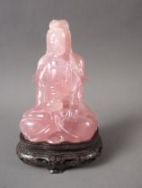 A Chinese rose quartz Buddha (chips to base and edges), on carved and silver inlaid wooden base, 4