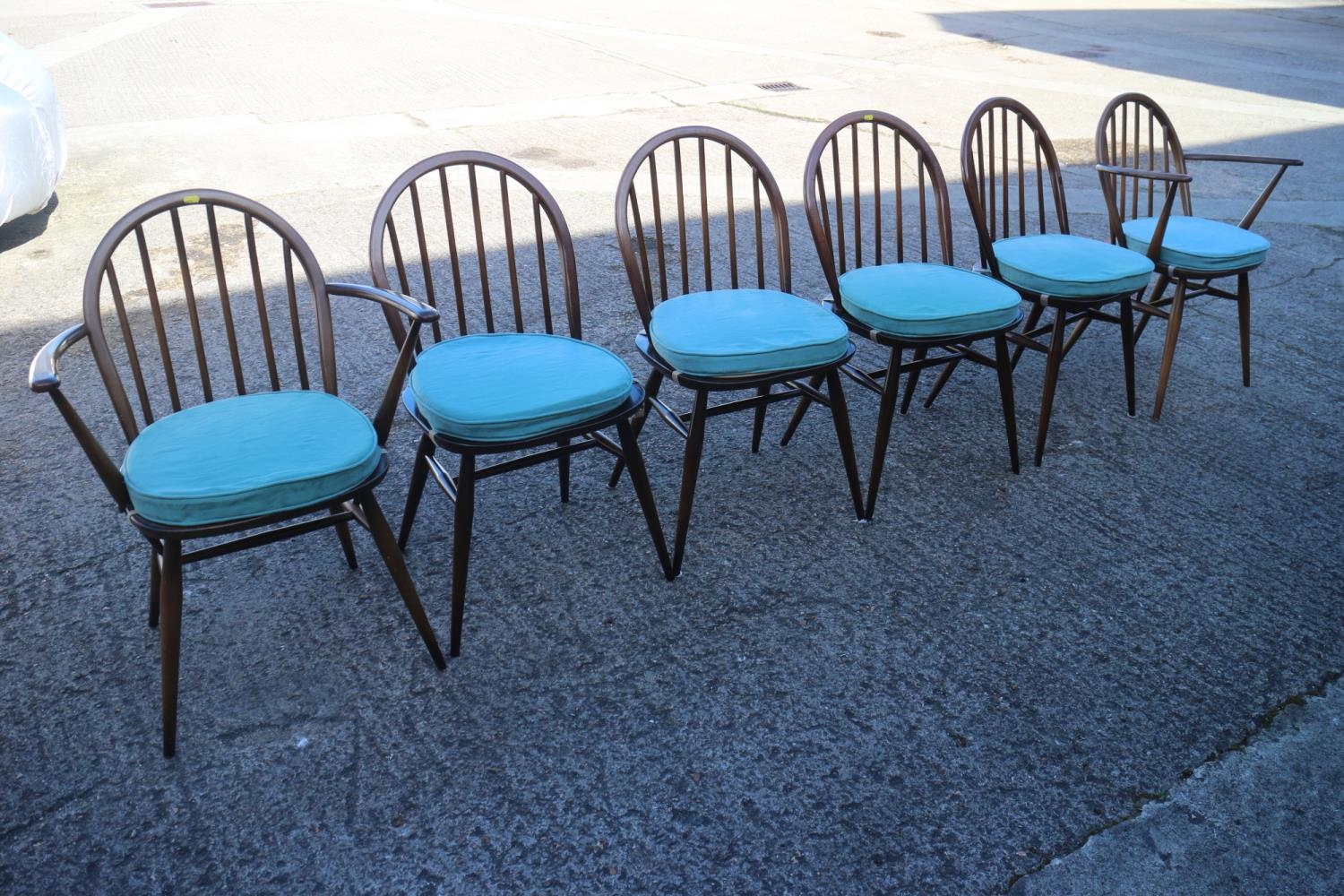 A set of six Ercol "Windsor" spindle back dining chairs with panel seats (4+2)