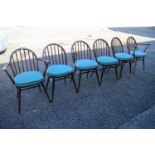 A set of six Ercol "Windsor" spindle back dining chairs with panel seats (4+2)