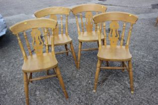 A set of four modern Windsor pierced splat back kitchen chairs, on turned and stretchered supports