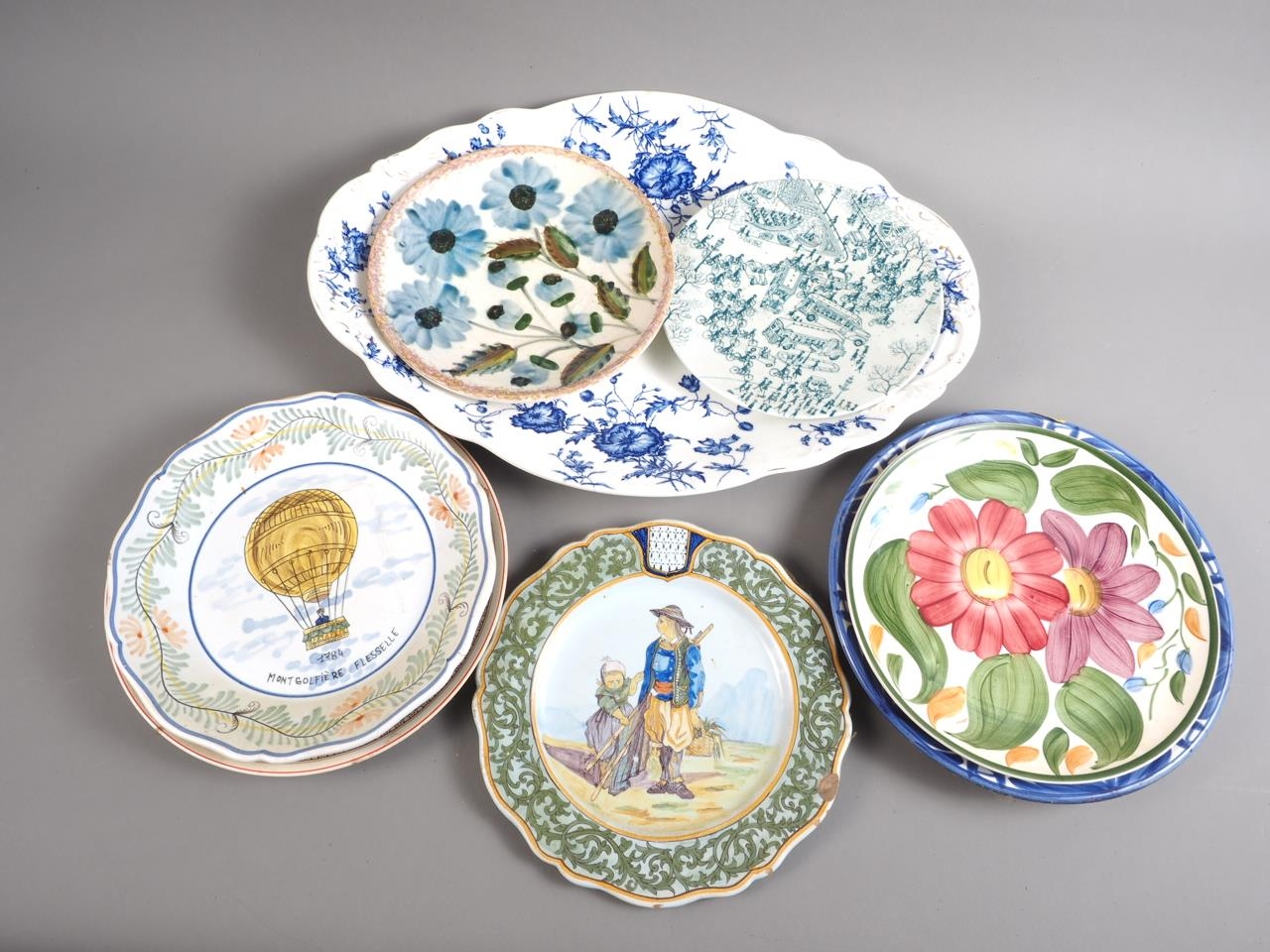 Two French faience plates, ballooning and fisher folk, and other decorative plates (chips to one