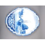 A Delft blue and white shaped wall plaque with boats in a river decoration, 19 3/4" high x 16 1/2"