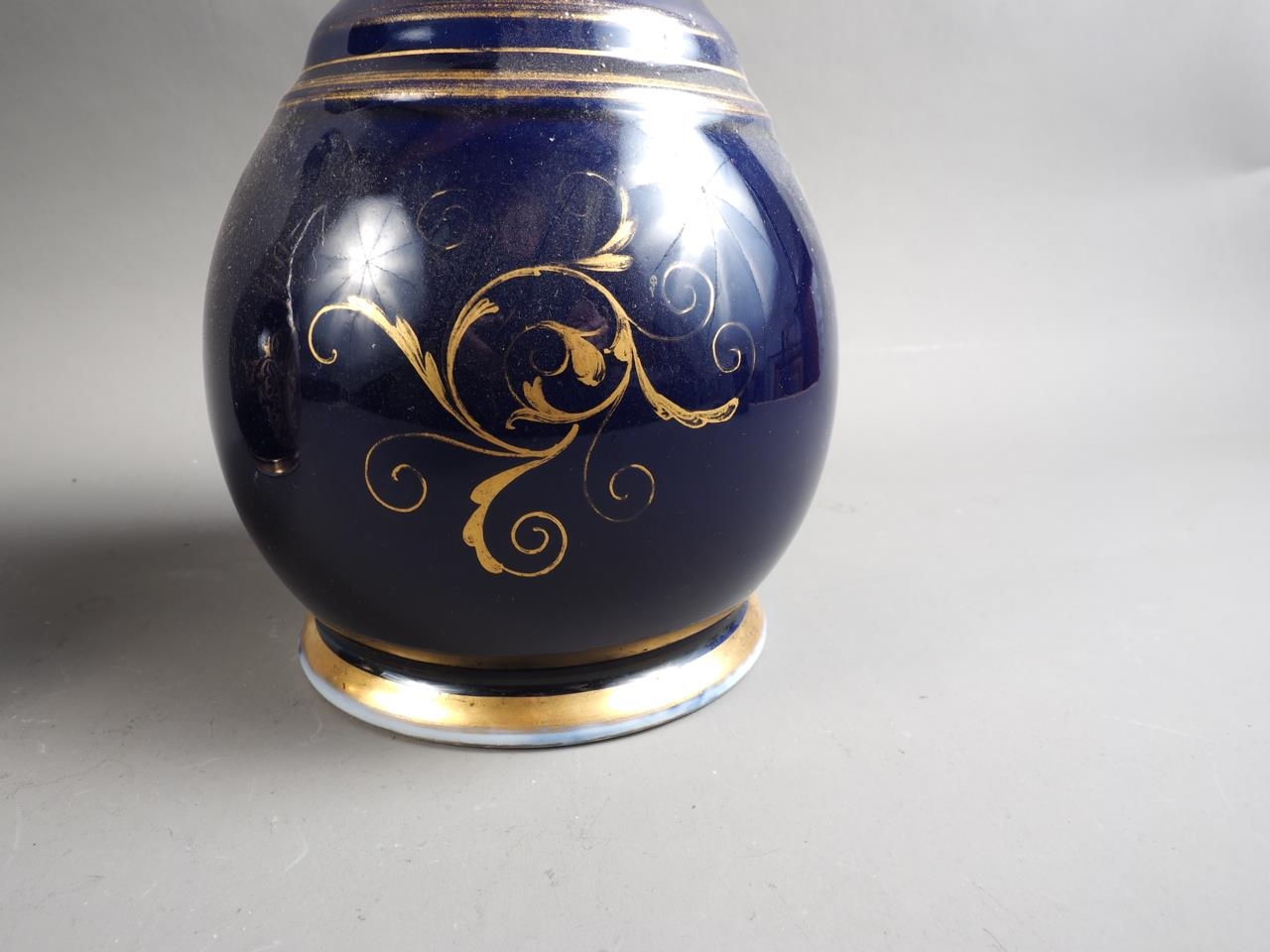 A pair of early 19th century bone china vases with flared rims and floral reserve panels on a blue - Image 5 of 16