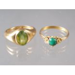 An 18ct gold and peridot single stone ring, size I, 6.9g, and a yellow metal and jade cabochon ring,