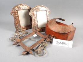 A pair of early 20th century copper photograph frames with embossed bird and flower decoration, 9