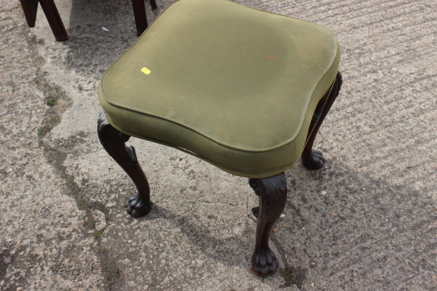 A 19th century carved mahogany shape top stool, on acanthus scroll supports and lion paw feet, 20"