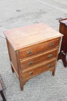A 1930s oak chest of three drawers, on moulded supports, 24" wide x 18" deep x 29" high