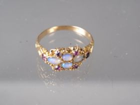 A Victorian yellow metal, opal and ruby dress ring, size L, 1.9g
