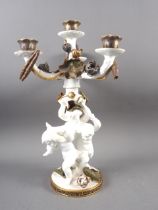 A 19th century Moores three-branch four-light candelabrum of cherub and floral design with gilt