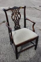 A Georgian provincial carver chair of Chippendale design with drop-in seat, on stretchered supports