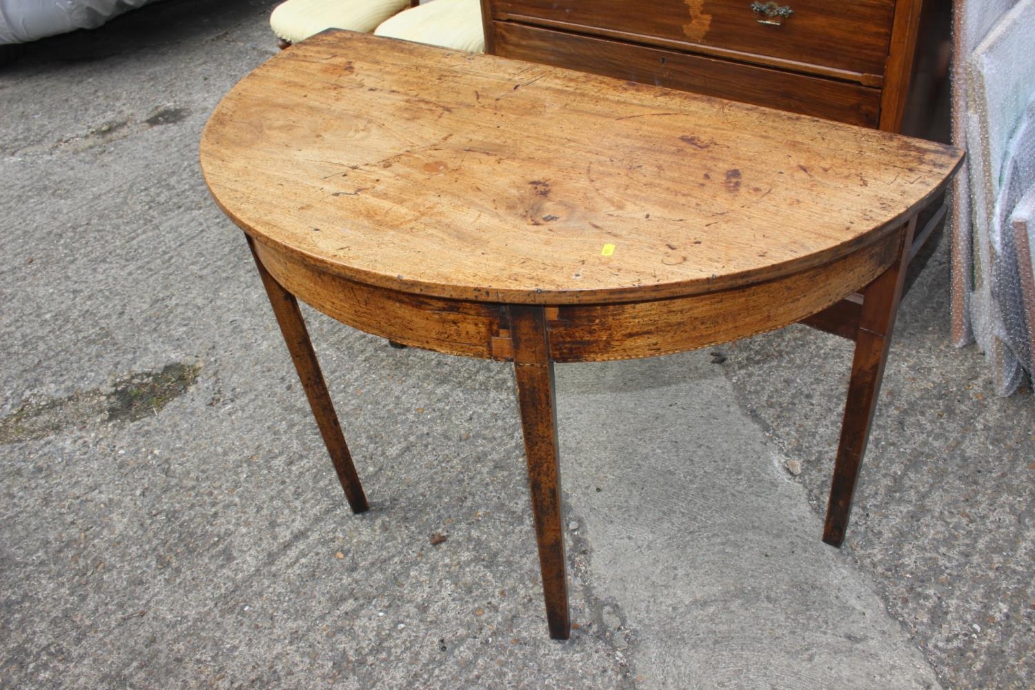 A 19th century mahogany semicircular side table, on square taper supports, 46" wide x 24" deep x 28"