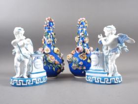 A pair of French porcelain figures of cherubs with column and altar, 7 3/4" high, and a pair of