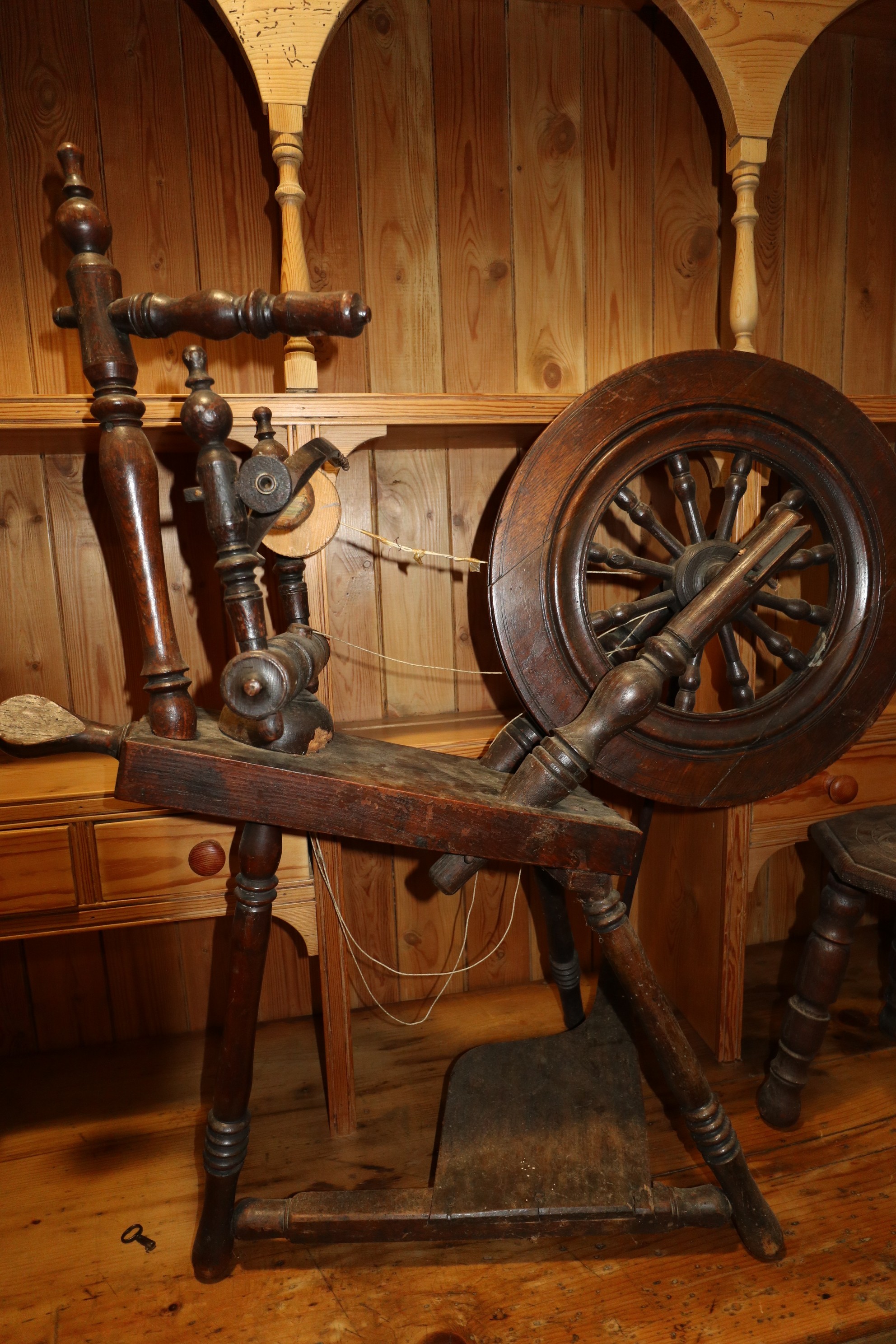 An oak and ash upright spinning wheel, 33" high, and a chip carved oak spinning stool with octagonal - Image 2 of 3