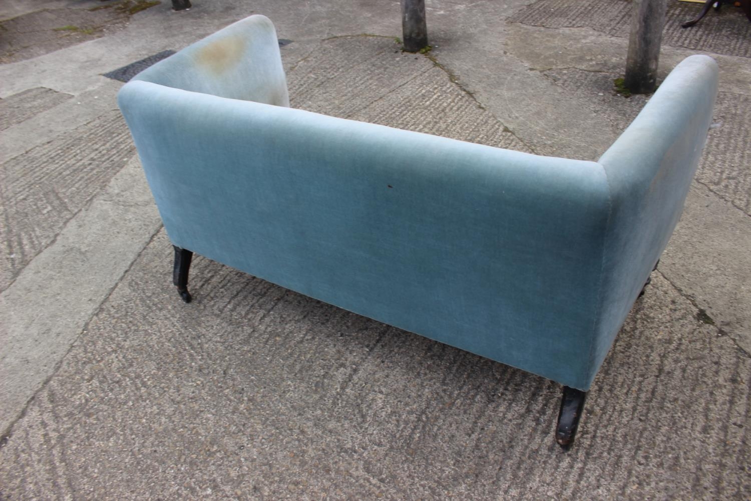 An early 20th century two-seat settee, upholstered in a blue velour, on ebonised turned and castored - Image 3 of 5