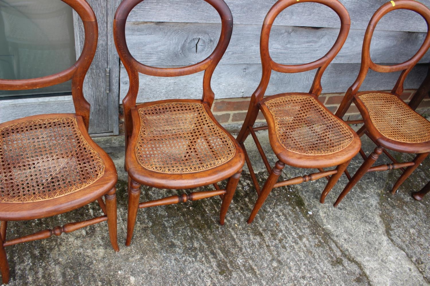 A set of four polished as walnut cane seat bedroom chairs, on turned splay supports - Image 2 of 3