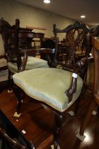 A pair of Edwardian carved mahogany showframe pierced slat elbow chairs, on cabriole supports