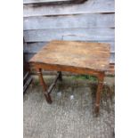 An 18th century oak side table with planked top, on turned and stretchered supports, 30 1/2" wide