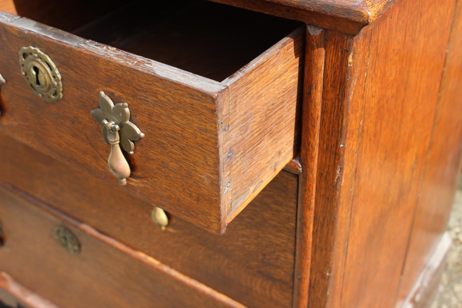 An 18th century oak chest of two short and two long drawers, on bracket feet with later brass - Image 2 of 2