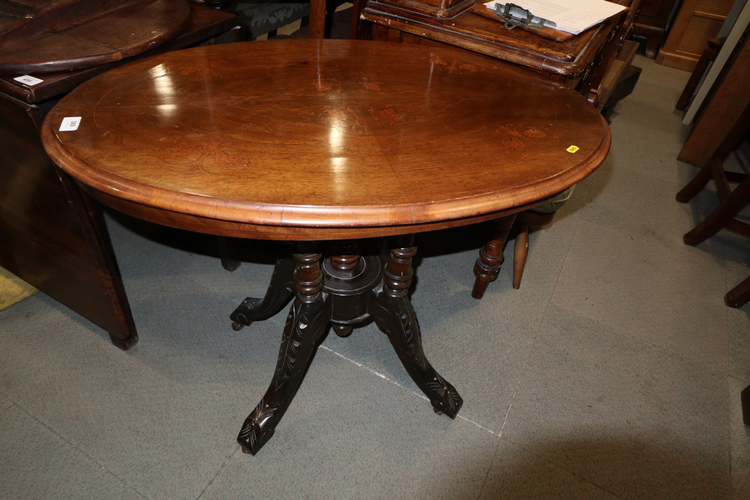 A 19th century walnut and inlaid tilt top occasional table, on quadruple turned splay supports,