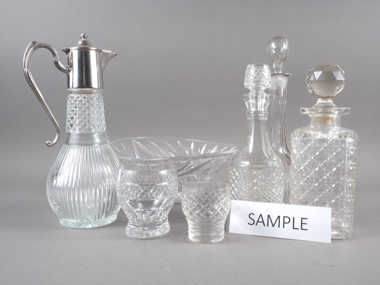 A glass and silver plate mounted claret jug, three decanters, two glass bowls and other items