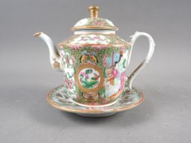A Canton enamel teapot, 5 1/2" high, and stand with figure, bird and insect decoration, 6" dia (