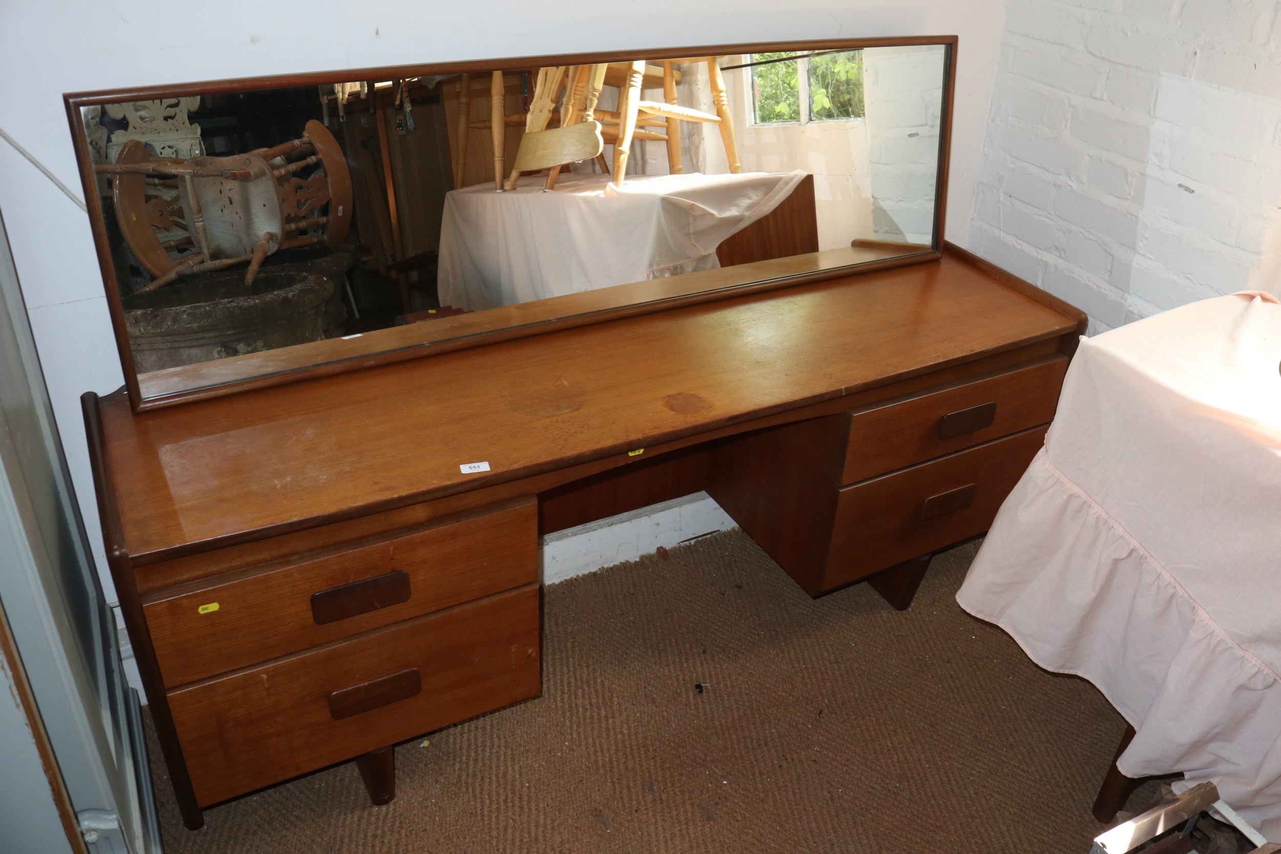 A 1960s teak knee hole dressing table, fitted four drawers and mirror over, 66" wide x 18" deep x