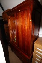 A cherrywood wardrobe enclosed two doors over two drawers, on square taper supports, 44 1/2" wide